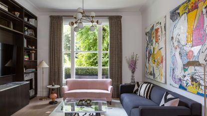 living room with pink sofa and large window