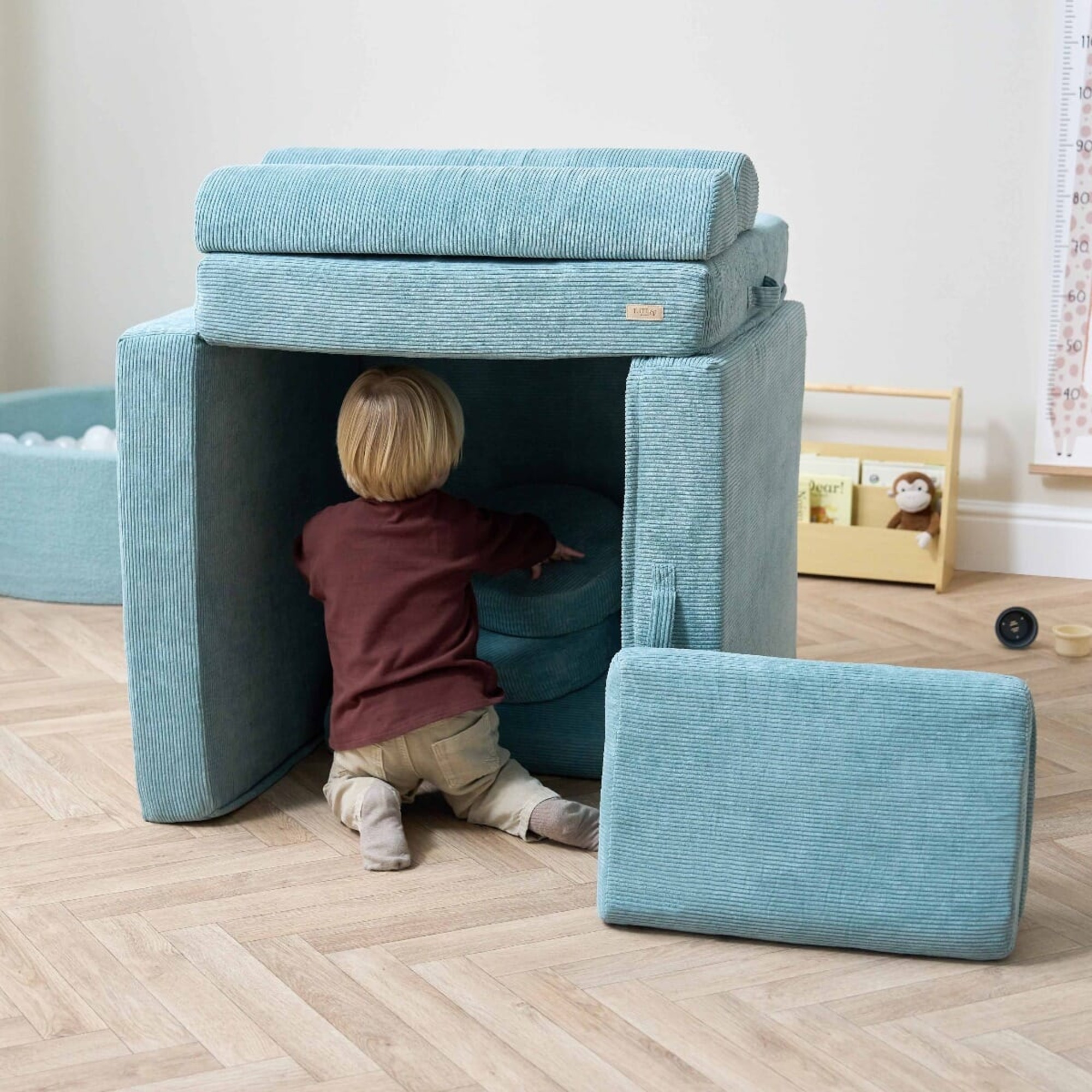 Tutti Bambini Playrama Kids Sofa in a playroom built like a fort with a little boy inside