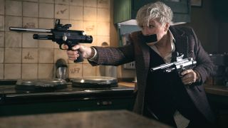 Glenn Close dual wields pistols in the kitchen with her mouth duct taped shut in Back In Action.