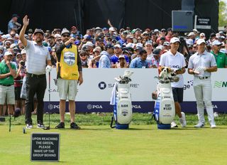 Michael Block and his caddie wait on the first tee with Rory McIlroy and his caddie