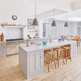 kitchen with wooden stools and white worktop