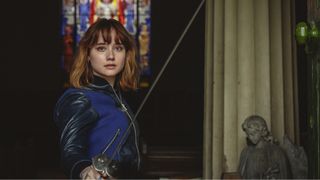 Lucy Carlyle (Ruby Stokes) holding a sword