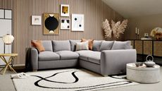 A corner sofa with grey upholstery in a modern open plan living room