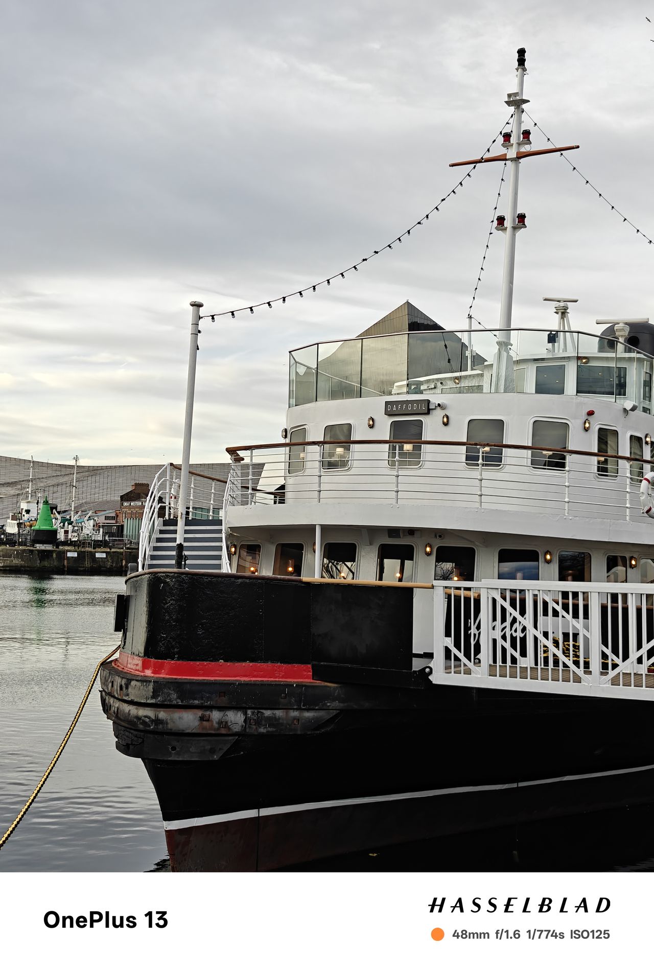 A boat moored in a harbor on a cloudy day