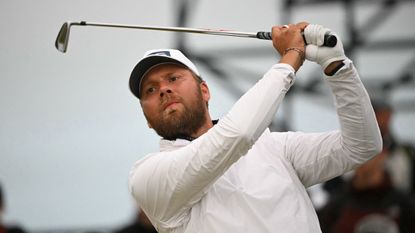 Daniel Brown hits an iron shot