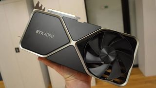 Hand holding Nvidia RTX 4090 graphics card with GamesRadar buying guide badge