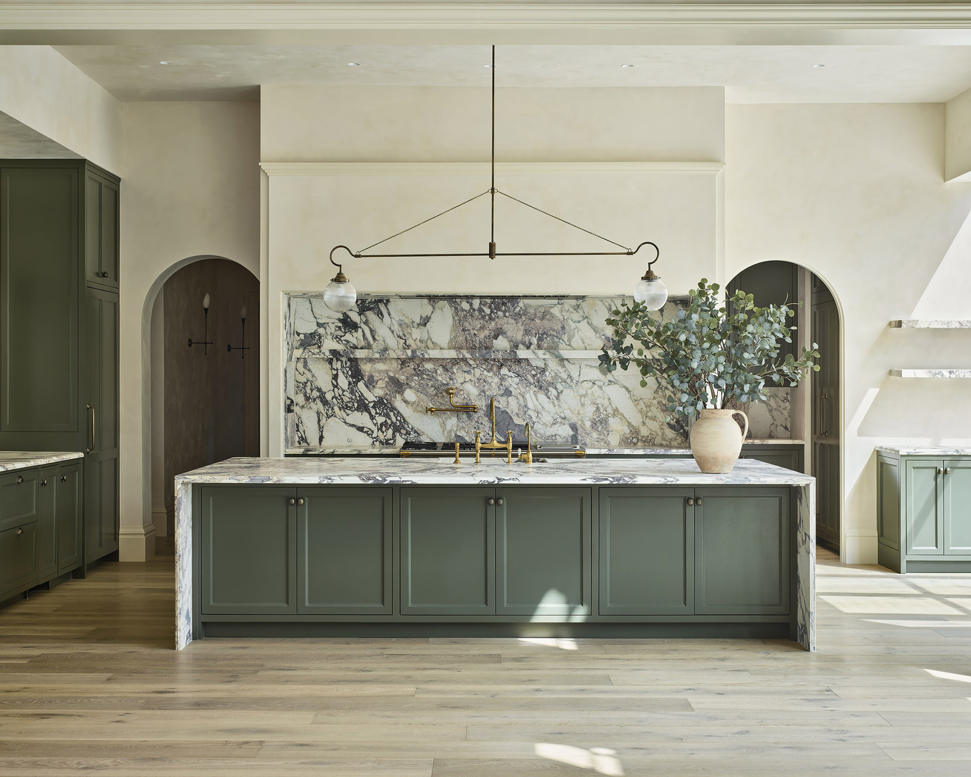 green kitchen with marble backsplash