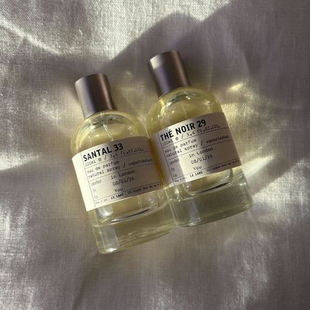 A picture of Le Labo perfumes on a white linen background