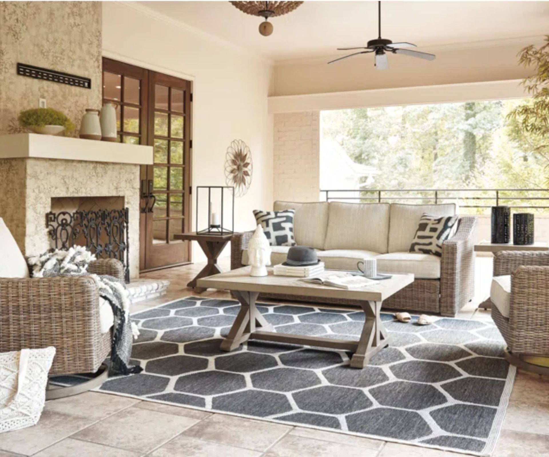 joss and main outdoor traditional patio living area with wicker sofa and armchairs and a grey and white geometric rug