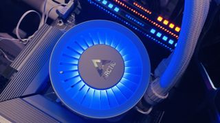 A cooling fan glowing blue, with the Arctic logo on top.