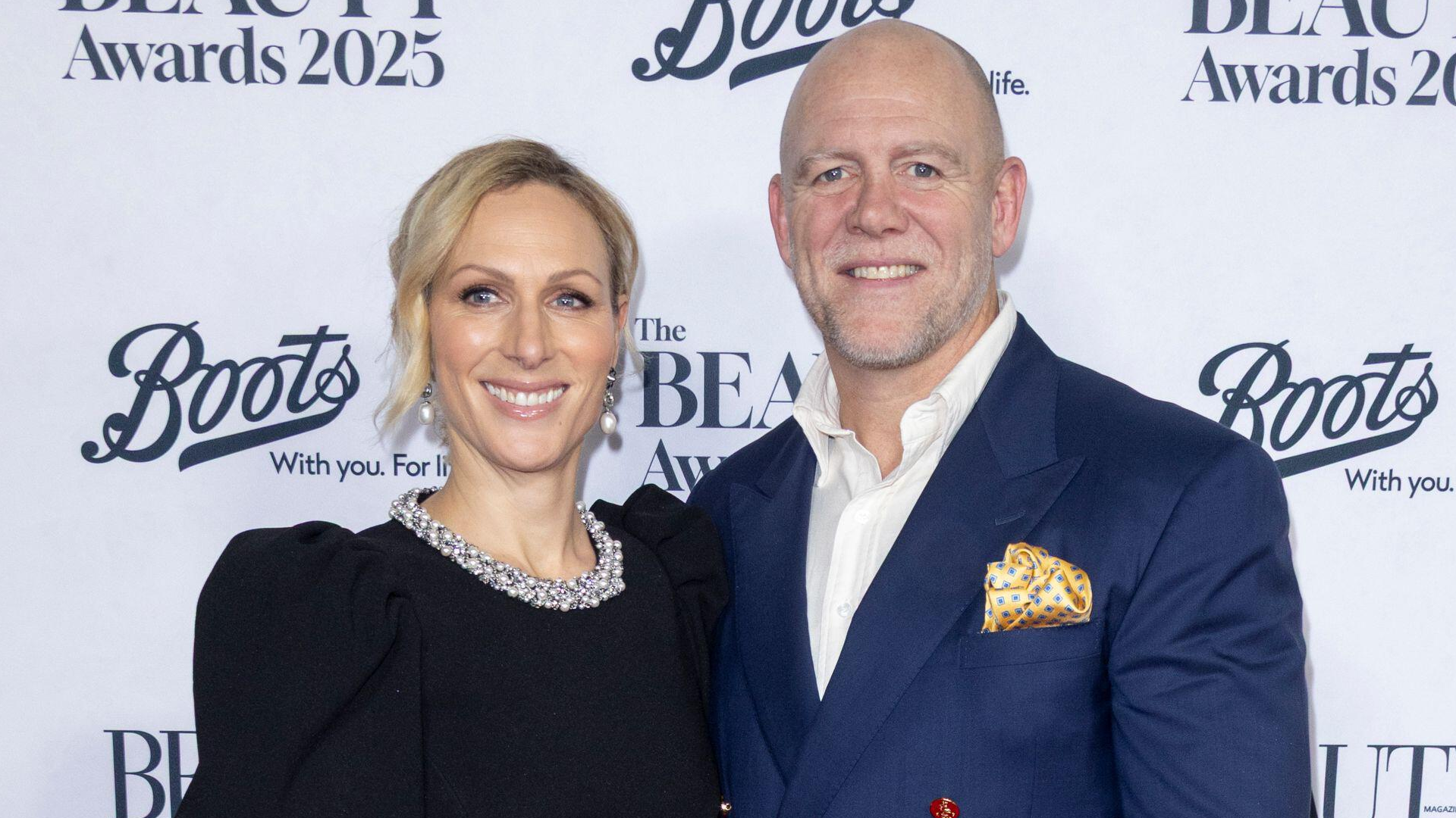 Zara Tindall wearing a black dress and Mike Tindall in a blue blazer at the Beauty Awards