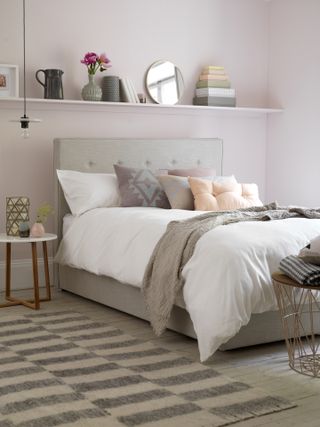 pink bedroom with pink shelf along the wall