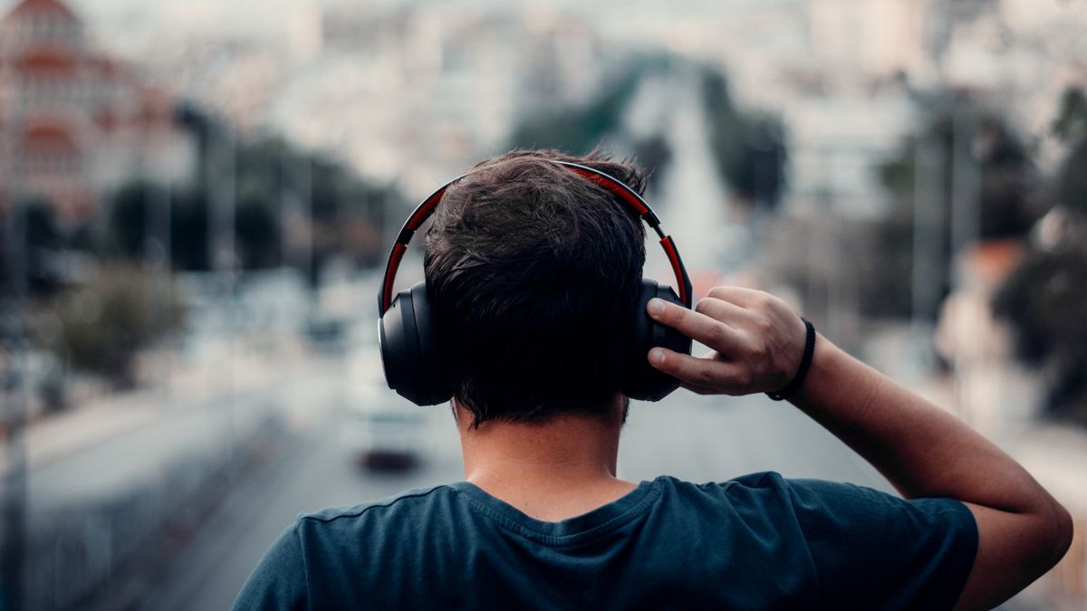 Back shot of man wearing SuperEQ headphones