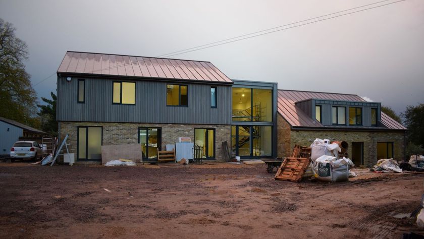 A newly built home with a cladded second storey and a metal roof