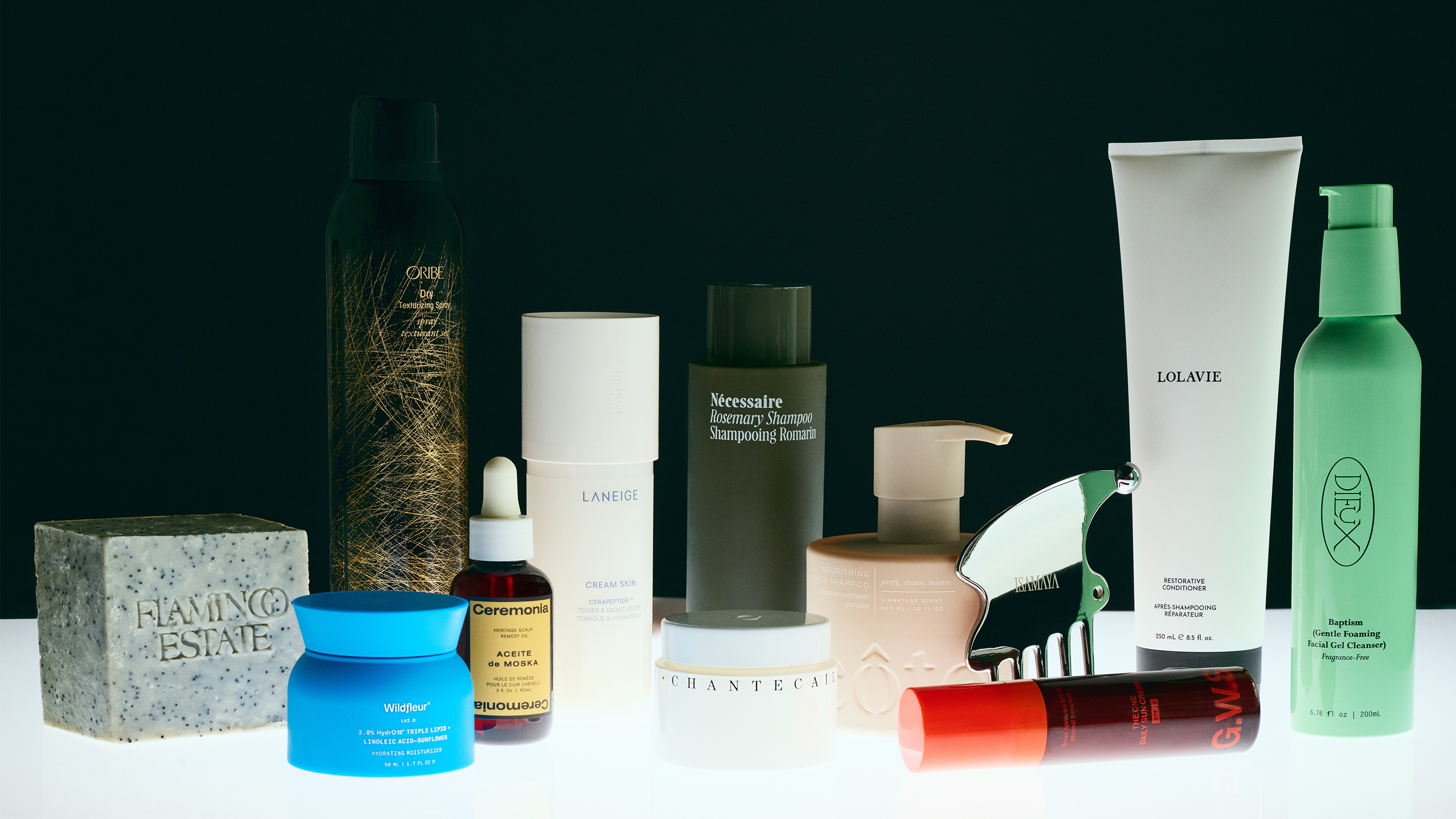 Hero of some products that won the 2025 skin and hair awards including flamingo estate soap, necessaire shampoo, lolavie conditioner, laneige toner and moisturizer, and more on a black background