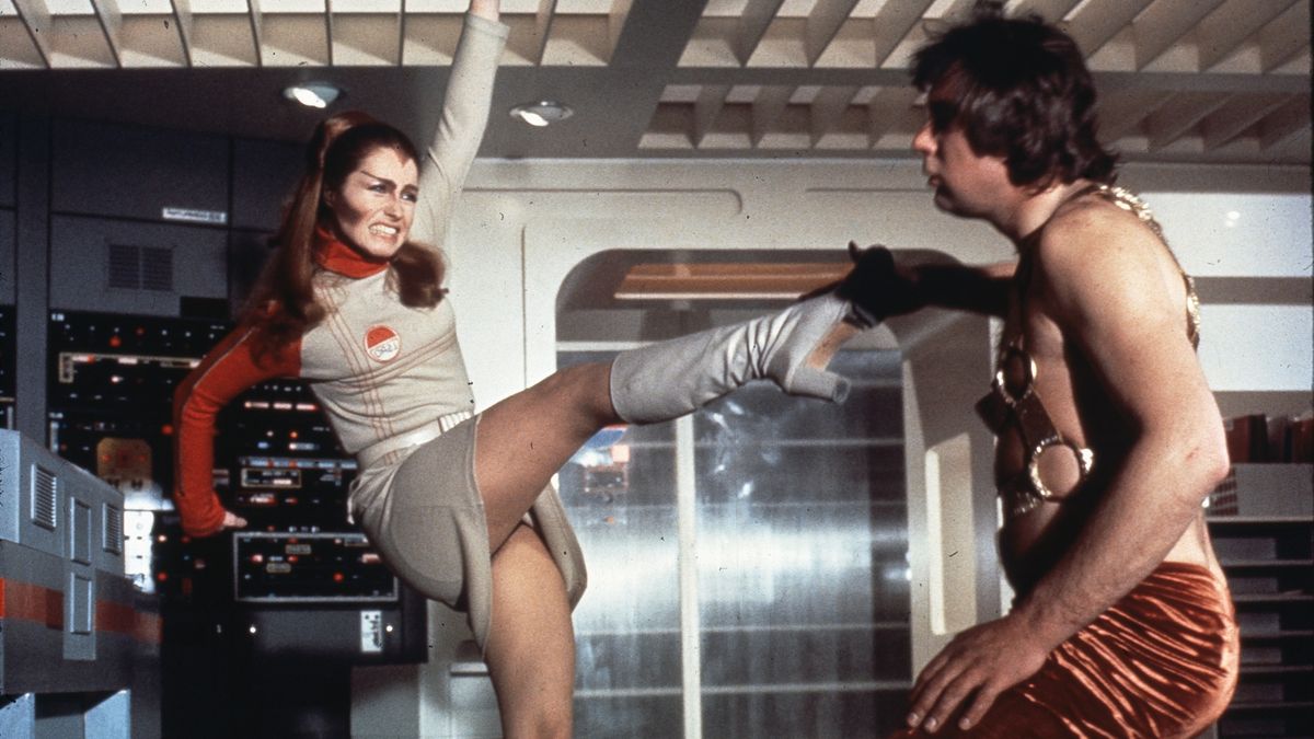 A woman high-kicking a man in Space: 1999.