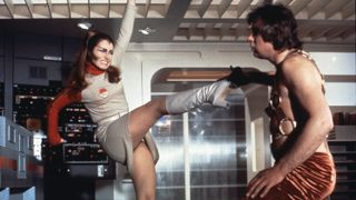 A woman high-kicking a man in Space: 1999.