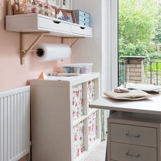 white and pink wall white drawer shelf and wrapping roll