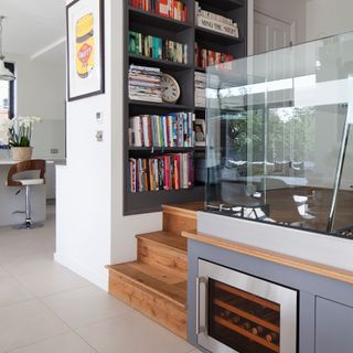 Mini mezzanine with built in wine fridge and bookshelves