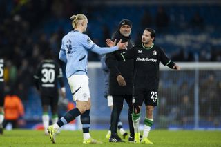 Manchester City striker Erling Haaland congratulates Feyenoord star Anis Hadj-Moussa after the full-time whistle