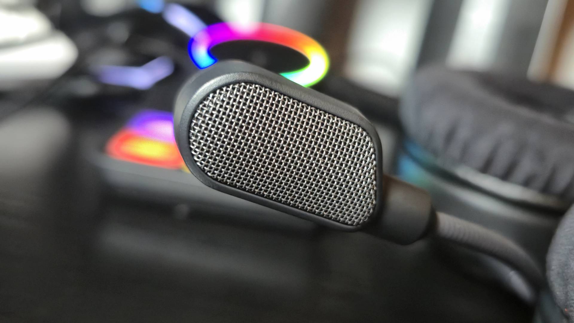 Close up image of the the grill on a black headset boom microphone.