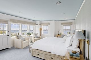 A bedroom at the White Elephant Nantucket with harbor views and a white bed