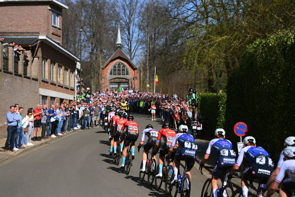 HARELBEKE BELGIUM MARCH 25 A general view of the peloton passing through village landscape during the 65th E3 Saxo Bank Classic 2022 a 2039km one day race from Harelbeke to Harelbeke E3SaxobankClassic WorldTour on March 25 2022 in Harelbeke Belgium Photo by Tim de WaeleGetty Images