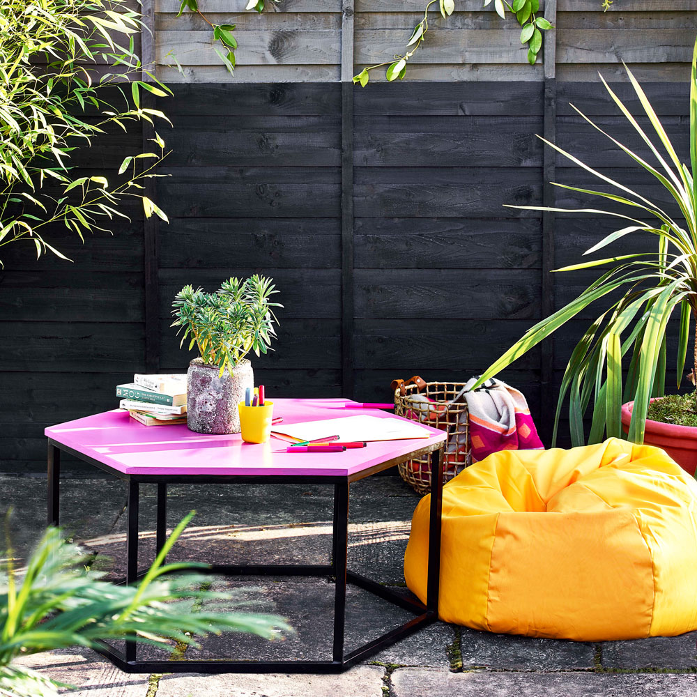 Garden with pink coffee table and yellow beanbag