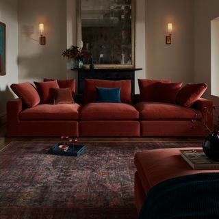 Sofa.com's Long Island sofa in a rusty red in a living room with a vintage-style Moroccan rug and ambient lighting