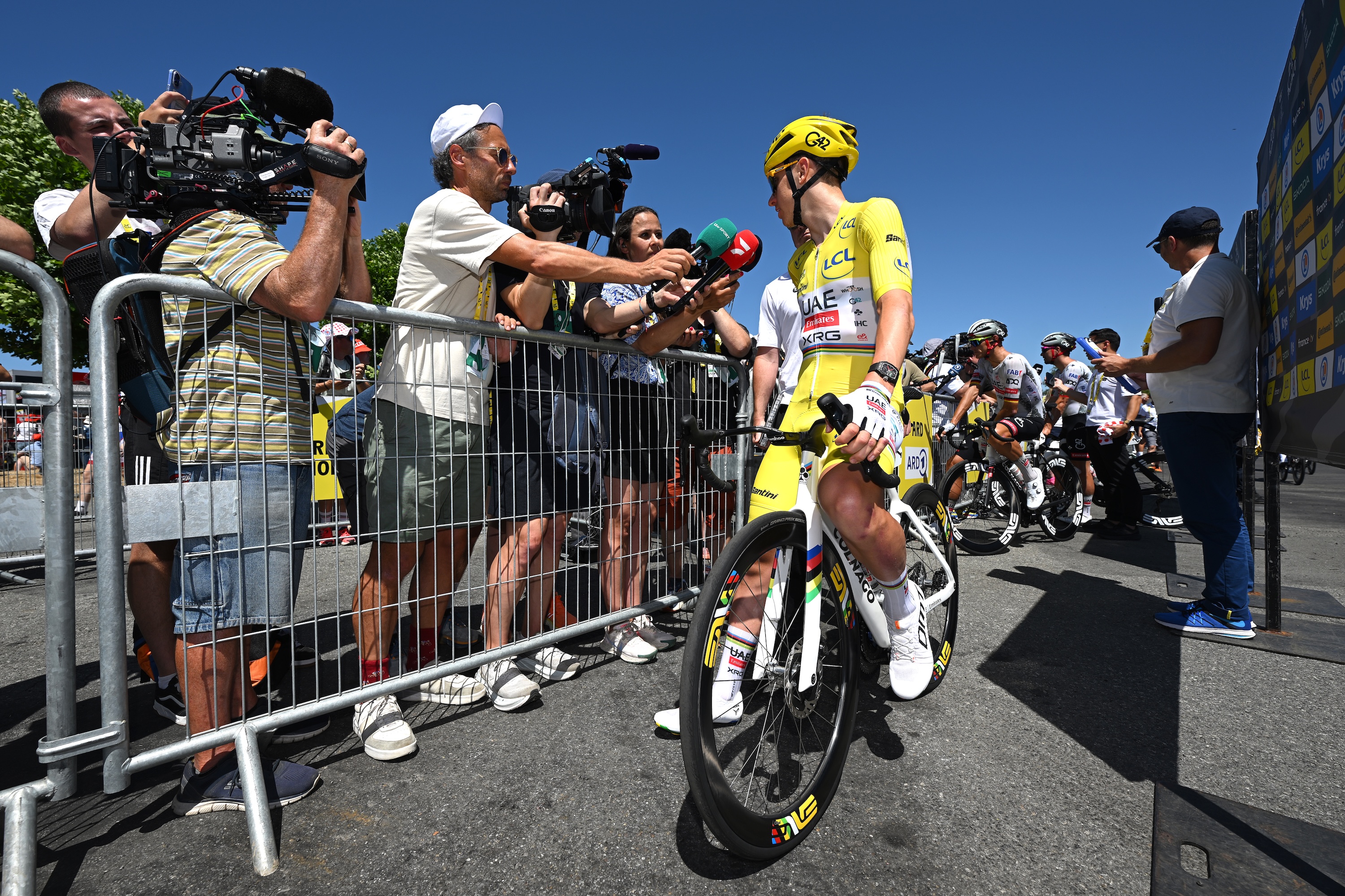 Tadej Pogačar is interviewed by the media ahead of a stage at the 2025 Tour de France