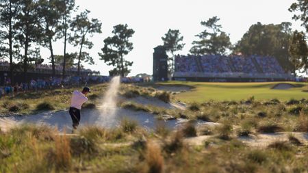 Bryson DeChambeau plays a bunker shot at the 2024 US Open