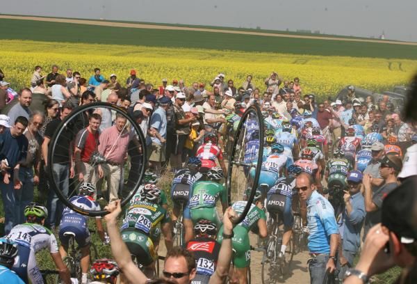 Busy, busy: Images like this one, from the 2007 edition, show why riders consider it to be such a battle just to finish Roubaix. With this many people operating on rough surfaces in such confined spaces, anything can and does go wrong.