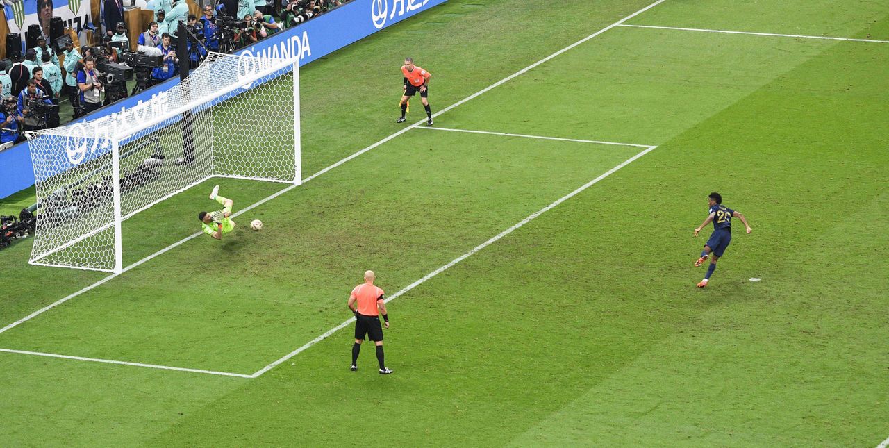 Argentina goalkeeper Emi Martinez saves a penalty from France's Kingsley Coman during the shootout in the 2022 World Cup final