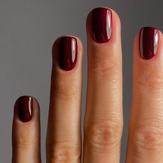 a close up of a woman's burgundy nails