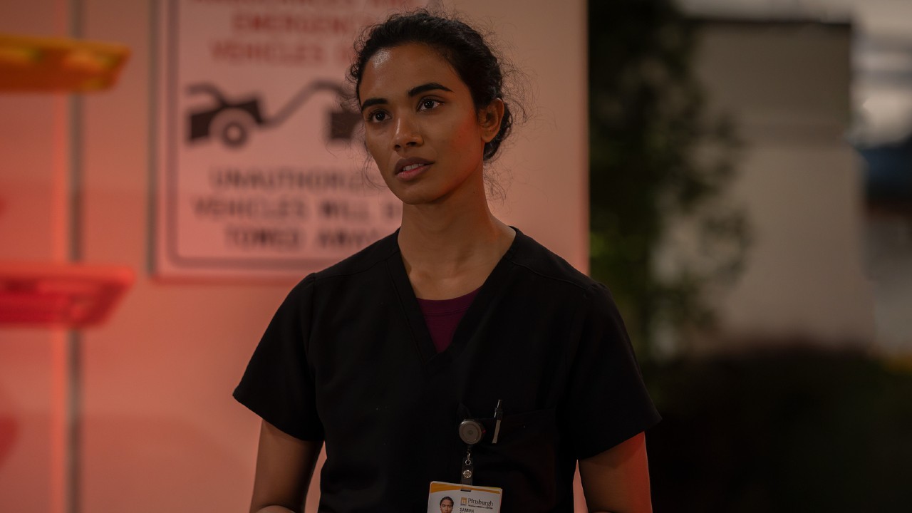 Supriya Ganesh as Mohan standing outside in The Pitt.