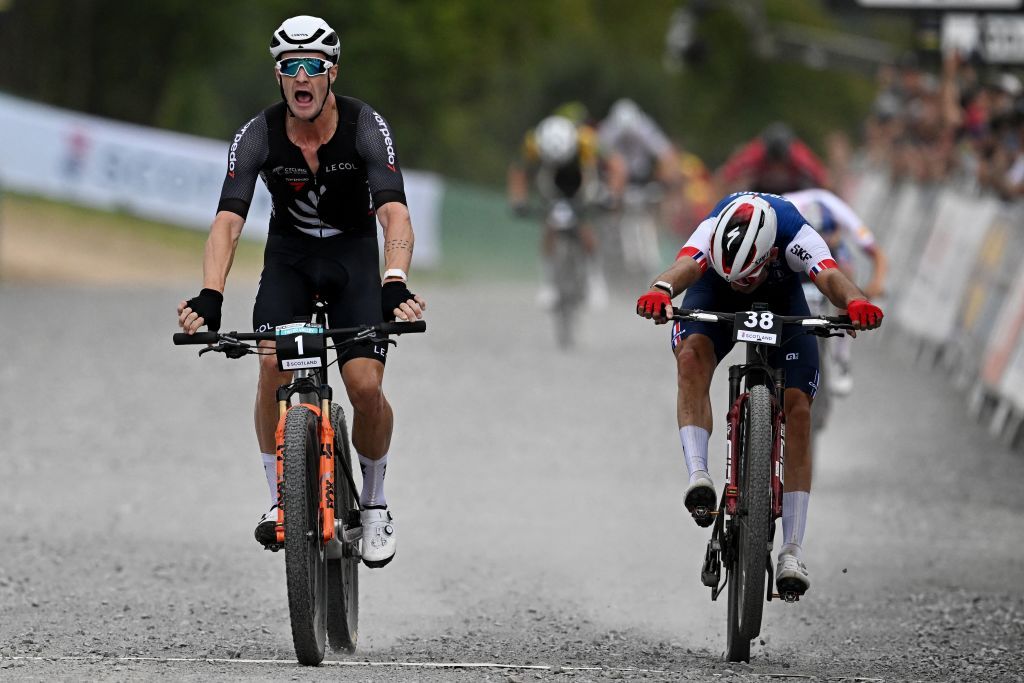 New Zealands Samuel Gaze L wins the mens elite mountain bike crosscountry short track race at the Cycling World Championships in Glentress Forest Scotland on August 10 2023 Photo by Oli SCARFF AFP Photo by OLI SCARFFAFP via Getty Images