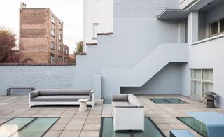 The roof terrace, with Lust's ‘Flow’ sofas for Indera, and a ‘Tavolero Travertino’ side table