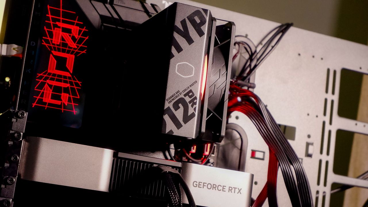 A Cooler Master Hyper 212 Pro air cooler with its packaging and installed on a gaming PC.