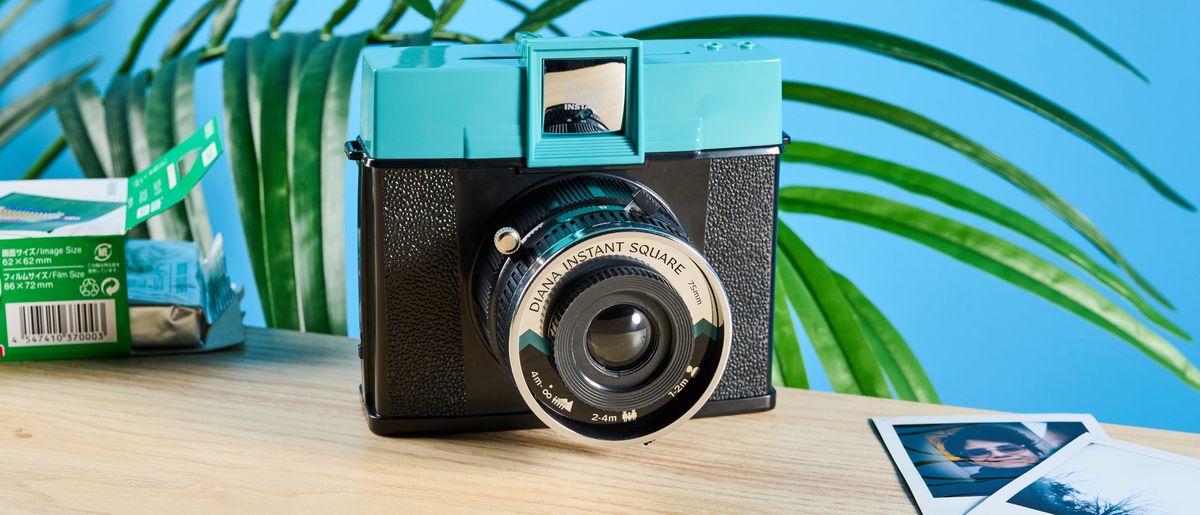 A black and teal Lomography Diana Instant Square instant camera