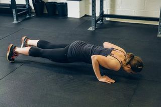 Image shows a cyclist doing core exercises.