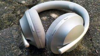 A close up of the bose noise cancelling headphones 700 headphones in white