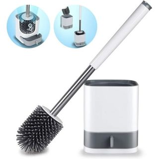 A black silicone toilet brush with a white handle next to a white plastic stand. 