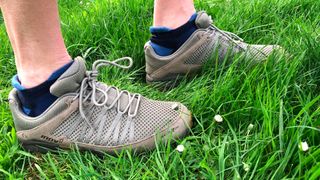 Man's feet wearing inov-8 Roclite Recycled 310 hiking shoes