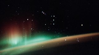 a 35mm photograph of a colorful display of the Southern Lights with a backdrop of the Orion constellation