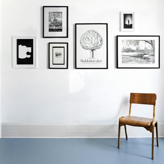 room with white wall and blue rubber flooring with chair