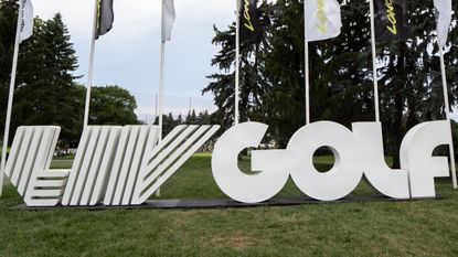 A LIV Golf sign in white at a LIV Golf tournament