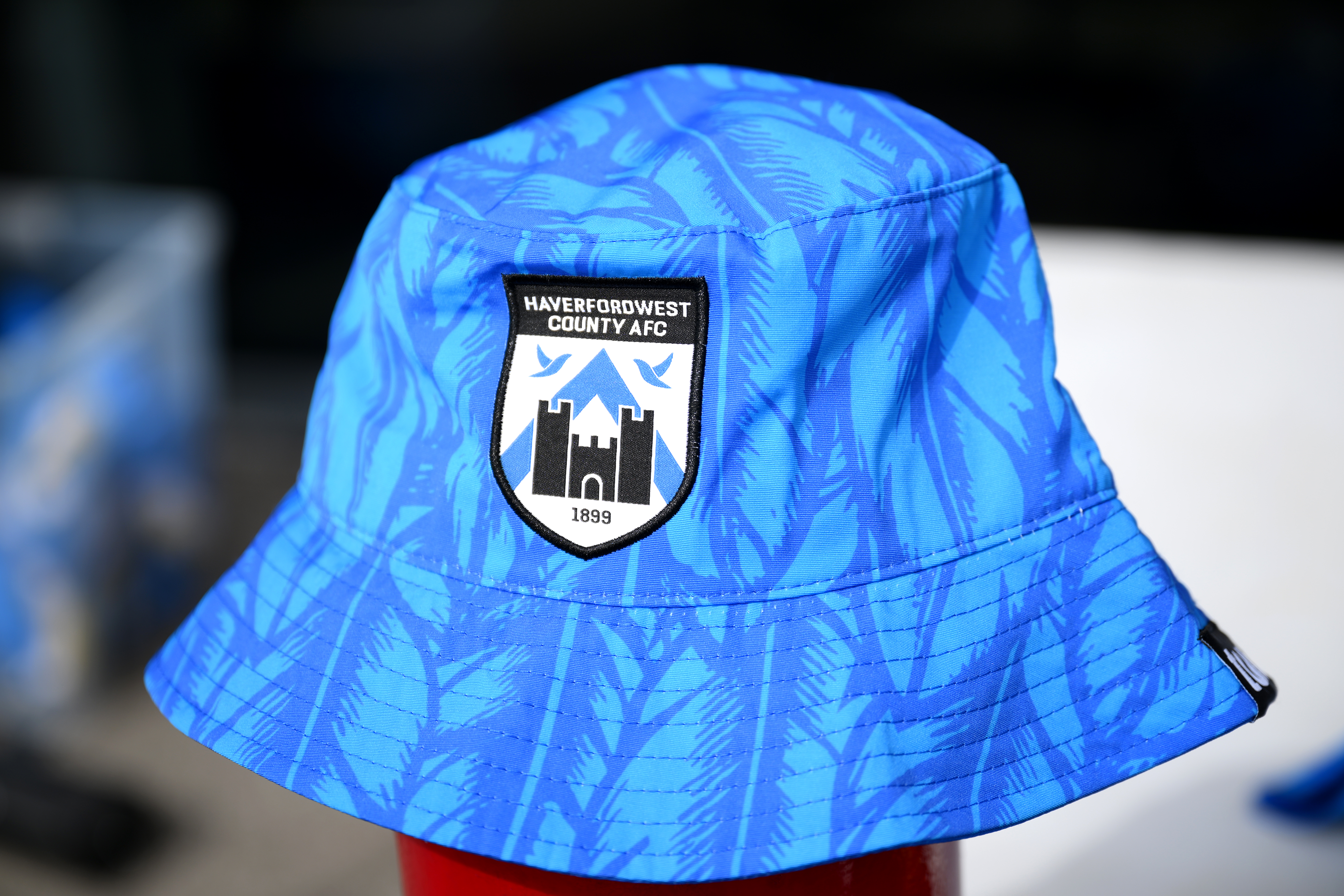 LLANELLI, WALES - JULY 17: A detailed view of a Haverfordwest County AFC branded bucket hat prior to the UEFA Europa Conference First Qualifying Round Second Leg match between Haverfordwest County and Floriana at Parc y Scarlets on July 17, 2025 in Llanelli, Wales. (Photo by Simon Galloway/Getty Images)