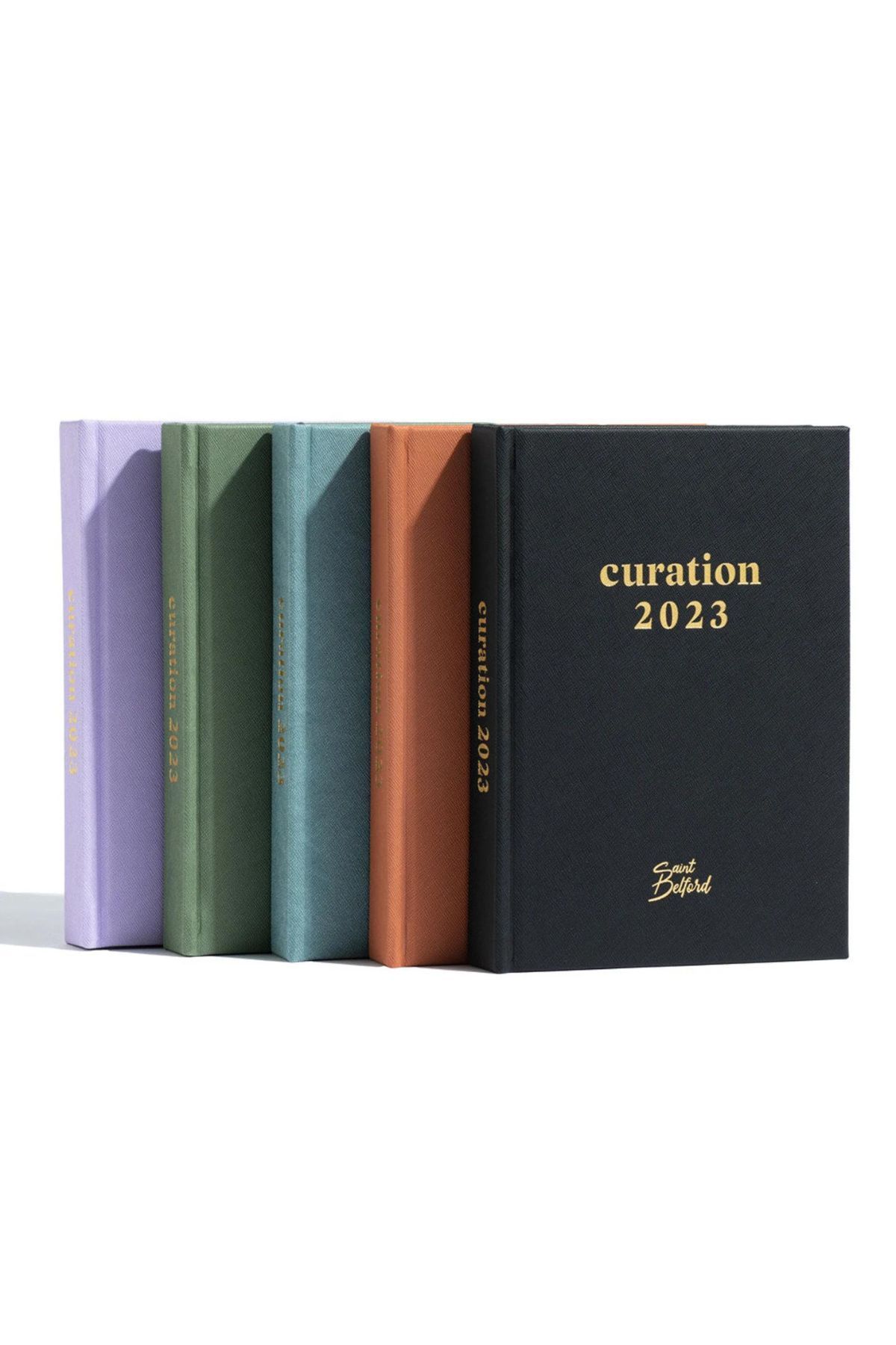 planners in different colors that say "Curation 2023"