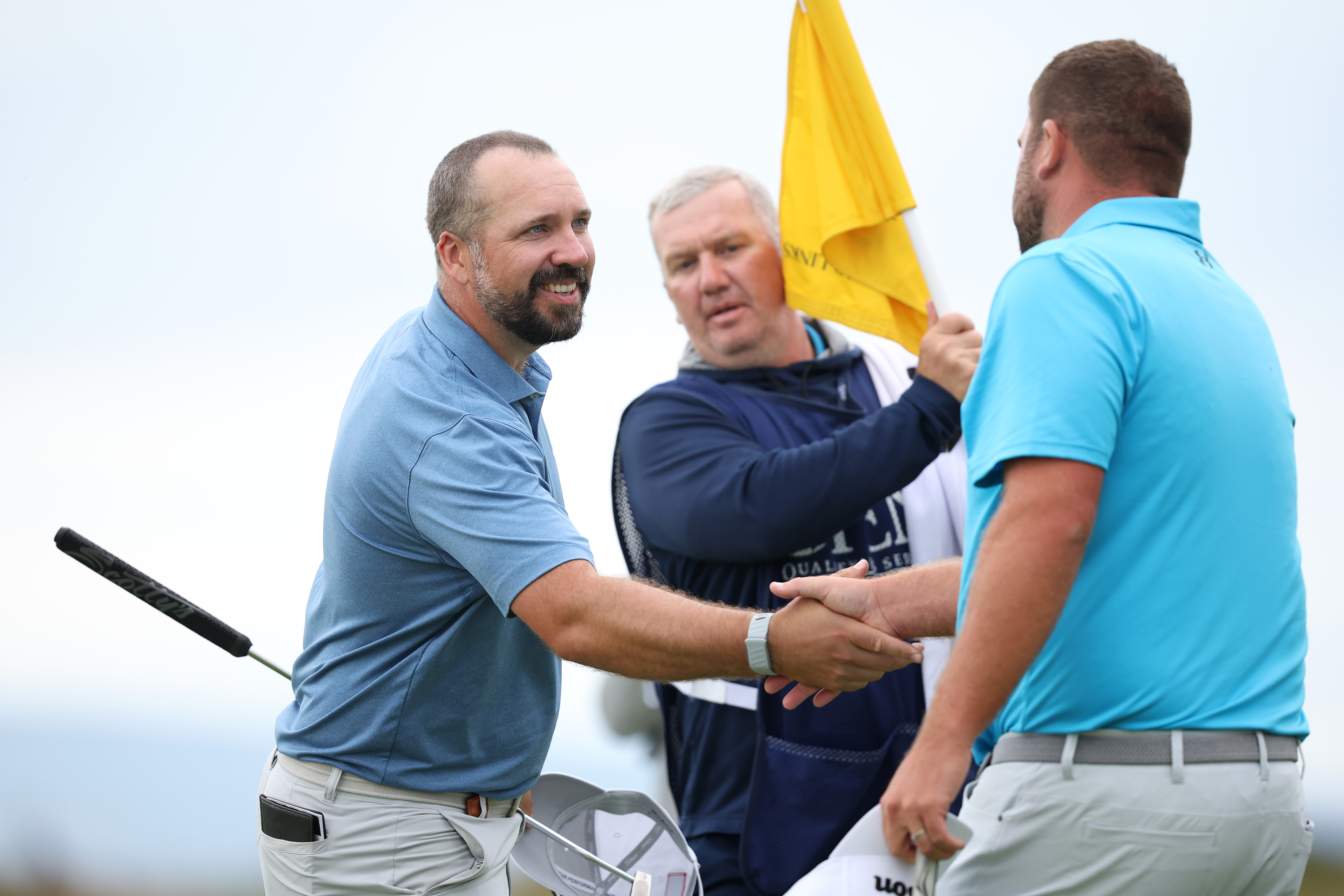 Peter Finch shakes hands with a golfer at Open Qualifying