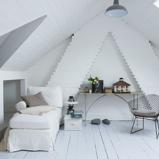 attic room with white wall and wooden floor